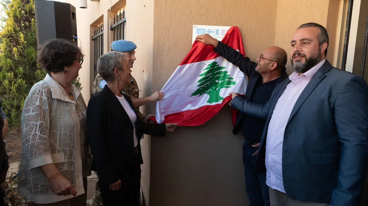 group of people unveiling a sign
