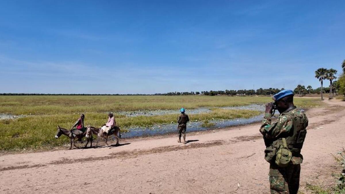 Villagers on the back of a donkey, peacekeepers on patrol.