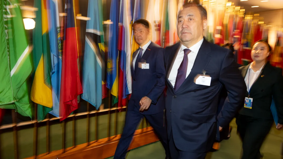 Khürelsükh Ukhnaa (left), President of Mongolia, walks through the hall of flags alongside Mongolian delegates at UN Headquarters on the first day of the 81st General Assembly Debate.