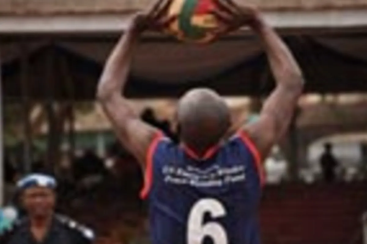 Playing the game, police and military personnel give volleyball their best shot in the qualifying games of the regional tournament.