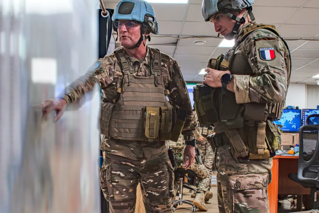 UN peacekeepers consult a map