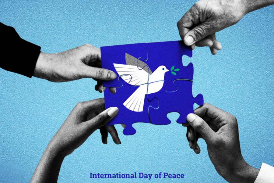 Four hands in black and white each holding a puzzle piece. Each puzzle piece is being held together to show a picture of a white dove and laurel.