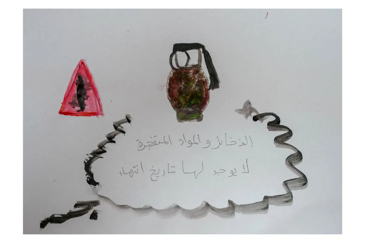 Drawing of a warning triangle and a grenade, with Arabic text about unexploded ordnance having no expiry date
