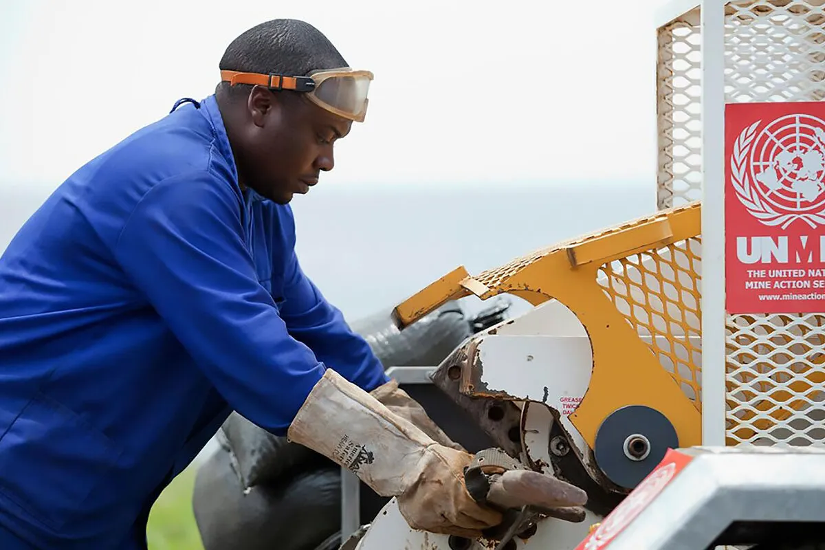 a man is destroying a weapon with a machine