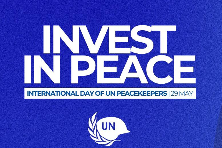 invest in peace banner featuring 3 peacekeepers