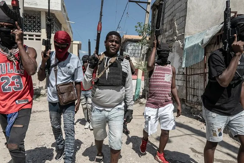 Gang members walk through a neighbourhood in Port-au-Prince.