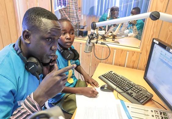 Individuals in a recording studio.