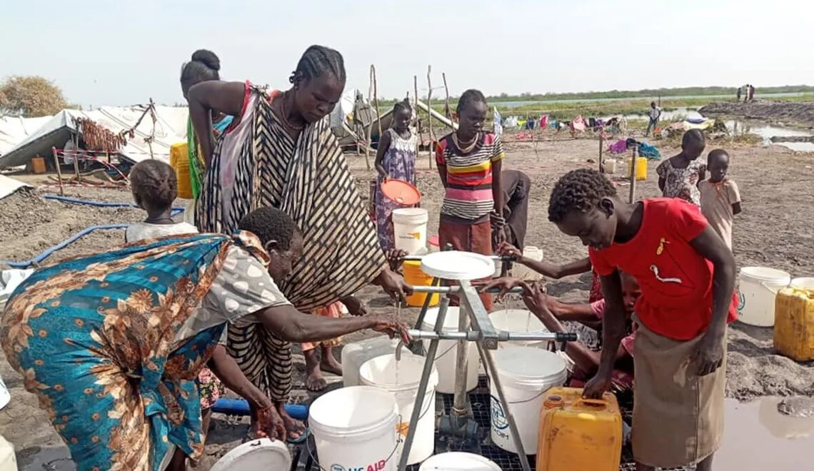 Some of the 20,000 displaced people in Kodok, South Sudan collect water. Photo credit: UN Photo/Nyang Touch